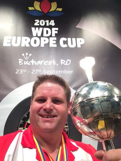 Scott holding the WDF Europe Cup August 2014 - Scott Mitchell Timeline
